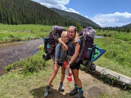 teenage girls hiking in colorado with backpacks