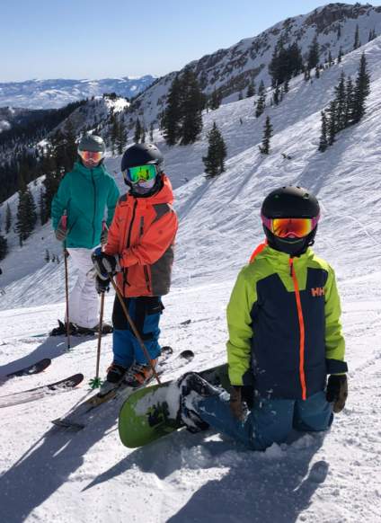 kids in ski goggles and masks on ski mountain