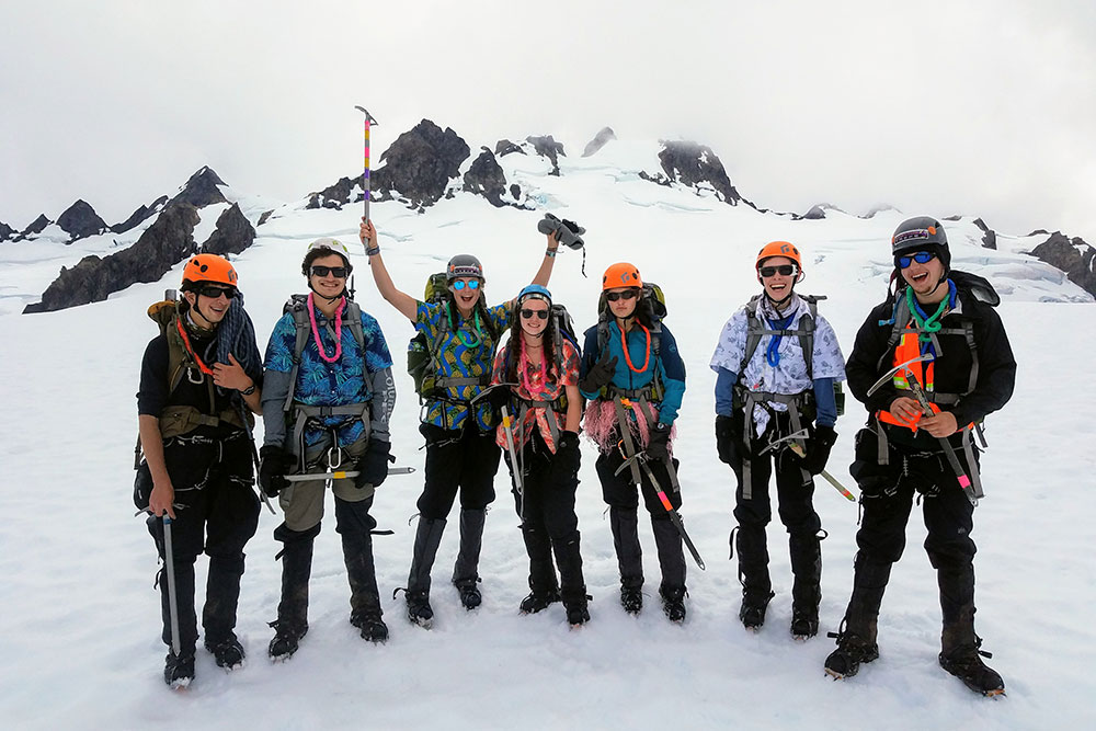 teenagers climbing and summiting mt. olympus in washington